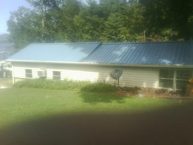 Blue metal roof running the length of a single story home in Fords