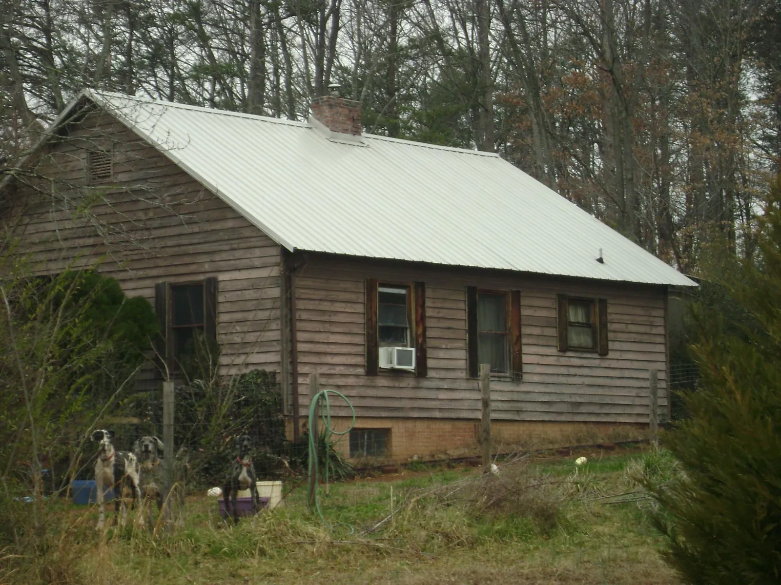 White metal roof on an old wood sided farmhouse, from a Asphalt Shingle Roof Repair job in Fords